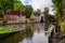 Bruges, Flanders, Belgium, Europe - October 1, 2019. Unknown people feed swans on the lake of love in Bruges Brugge in autumn.