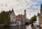 Bruges, West Flanders, Belgium, October 19, 2018: View of medieval buildings, tower of Belfry and water canal from Rozenhoedkaai