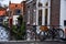 Brugge, Belgium - 12.12.2019 - A bike leaned against a metal fence overlooking a canal in Brugge, Belgium. Beautiful old brick bui