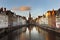 Brugge evening cityscape. Old buildings at water channel in Bruges