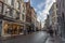 Brugge, West Flanders / Belgium - January 2017: streets of old Brugge one sunny winter day, houses, shops, blue sky with clouds