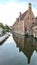 Brugges at sunset , the refection of the building and the tower in the water of canal. Vertical photo 16:9