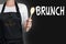 Brunch cook holding wooden spoon background