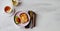 Brunch - an egg with sesame seeds on toast, fresh cucumber and tomato. A cup of tea with lemon. In the background is a can of