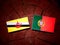 Brunei flag with Portuguese flag on a tree stump isolated