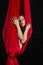 Brunette acrobat in red silk