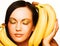 Brunette with bananas on a white background