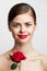 Brunette with bare shoulders Red rose luxury smile body care