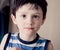 brunette boy wearing striped shirt indoor