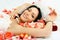 Brunette bride on the bed covered with rose leaves