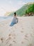 Brunette bride in blue wedding dress at beach in Bali