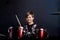 A brunette child boy plays the drums. Studying in the studio.