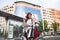 Brunette cool woman with bike walking in the street