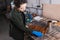 Brunette craftswoman applying wood stain on