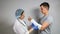 Brunette doctor examines broken forearm of young man
