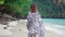 Brunette fashion model walking at tropical paradise beach, dresses on zebra tunic