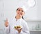 Brunette girl chef and plate with salad