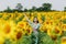 Brunette girl in a field of sunflowers like in the shower