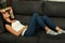 Brunette girl with headache resting on the sofa