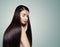 Brunette girl with long dark brown straight hair, haircare concept