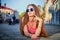 Brunette girl lying on the cobblestones in the central part of the old city in a sunny summer day