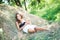 Brunette girl is lying on haystack in summer sunny