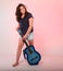 Brunette girl playing blue guitar