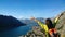 Brunette girl stands on top of a mountain and looking in the direction of Boko-Kotor Bay to Kotor in Montenegro. Traveler