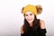 Brunette girl in in yellow cap with brown bobbles