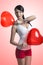 brunette with heart shaped balloons on the shoulder