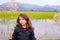 Brunette kid girl outdoor holding spike in wetlands lake