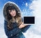 Brunette lady presenting a tablet outside - winter, chill day