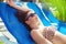 Brunette lady relaxing at the hotel`s swimming pool