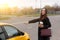 Brunette with long hair, asking taxi stop