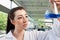 Brunette looking at an Erlenmeyer flask