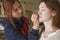 Brunette make up artist woman applying make up for a caucasian b