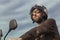 Brunette man with brown leather jacket on a motorbike