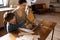 Brunette mother, daughter and son using a laptop, while mom drinking breakfast coffee