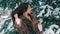 Brunette rich woman waist coat of brown fur on background of Christmas tree slow motion