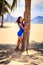 brunette slim girl in short blue frock barefoot