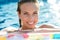 Brunette smiling woman relaxing in pool