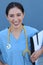 Brunette spanish doctor woman with a clipboard on blue background