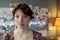 Brunette teenage girl with oxygen nose pipe standing in hospital ward