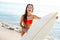 Brunette teenager surfer bikini girl with surfboard