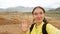 Brunette traveler girl takes a selfie on a smartphone. A trip to the bright mountains of Kyzyl-Chin in the Altai Republic