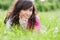 Brunette in white laying in grass