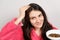 A brunette woman applies a natural Ayurvedic blend of herbs to her hair, scalp mask and scrub, hair care at home.