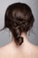 Brunette woman from backside on gray background