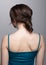 Brunette woman from backside on gray background