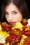 Brunette woman behind flowers